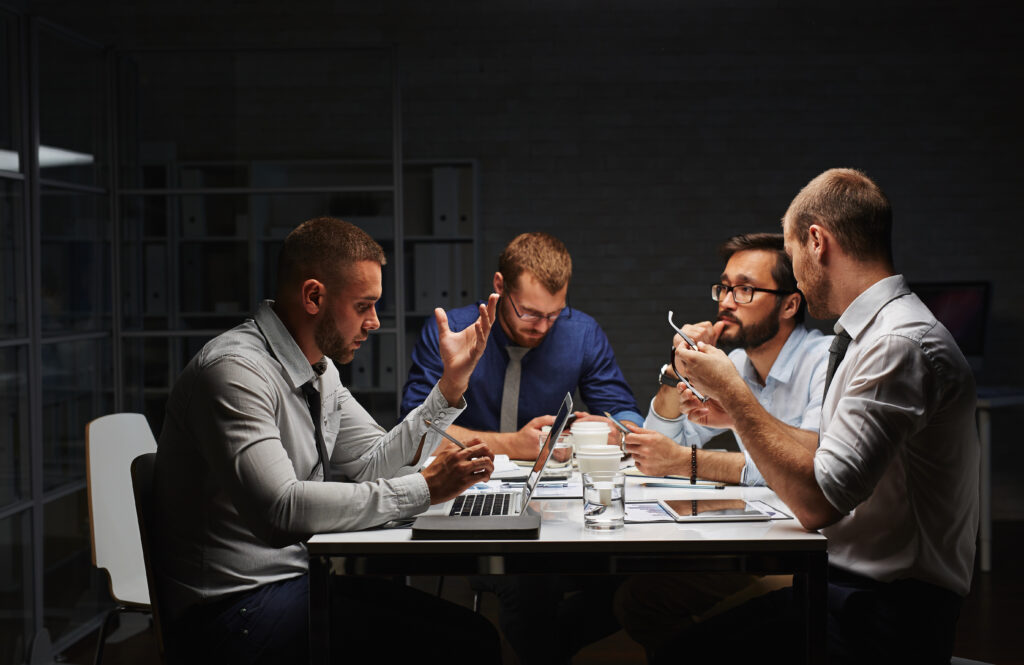 Group of creative designers working late in office