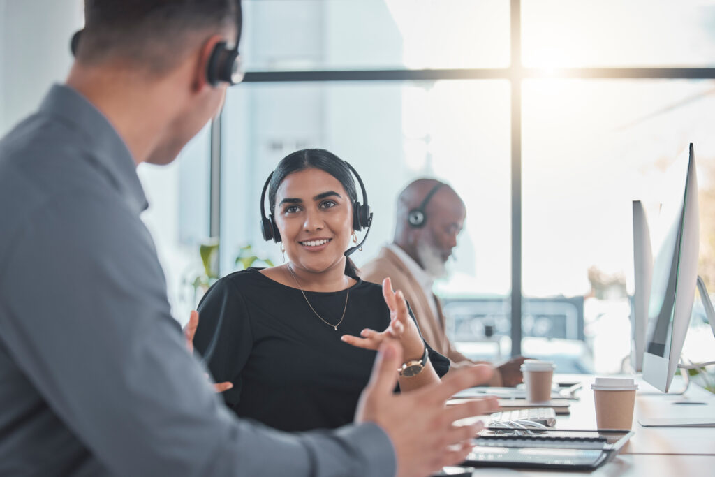 Telemarketing, teamwork or people  in call center talking in communications company workplace toget.