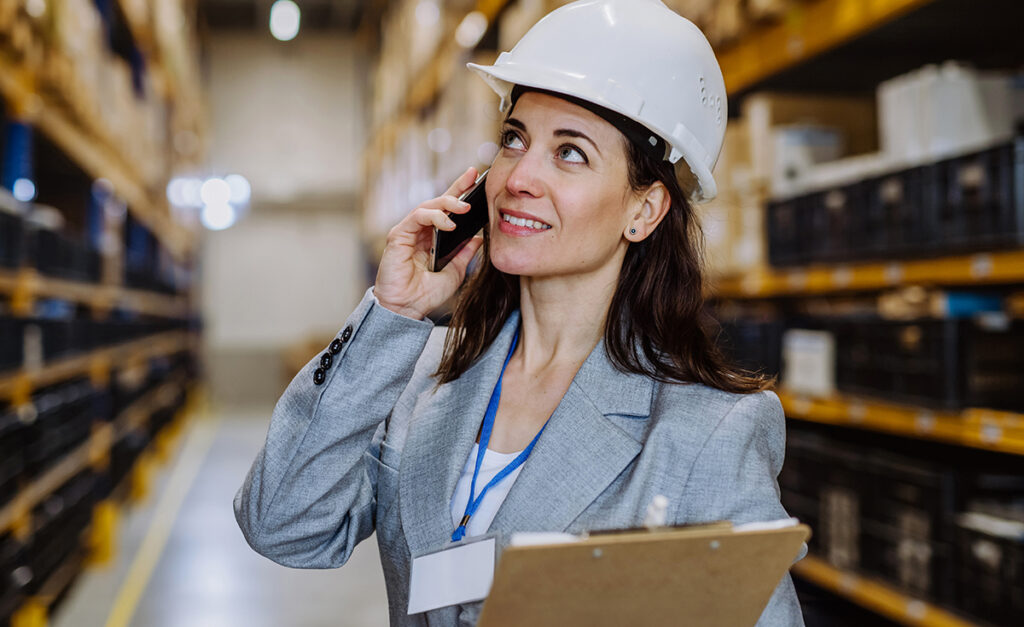 Woman in hardhat inspecting a warehouse for Big Outsource blog about Outsourcing warehouse management